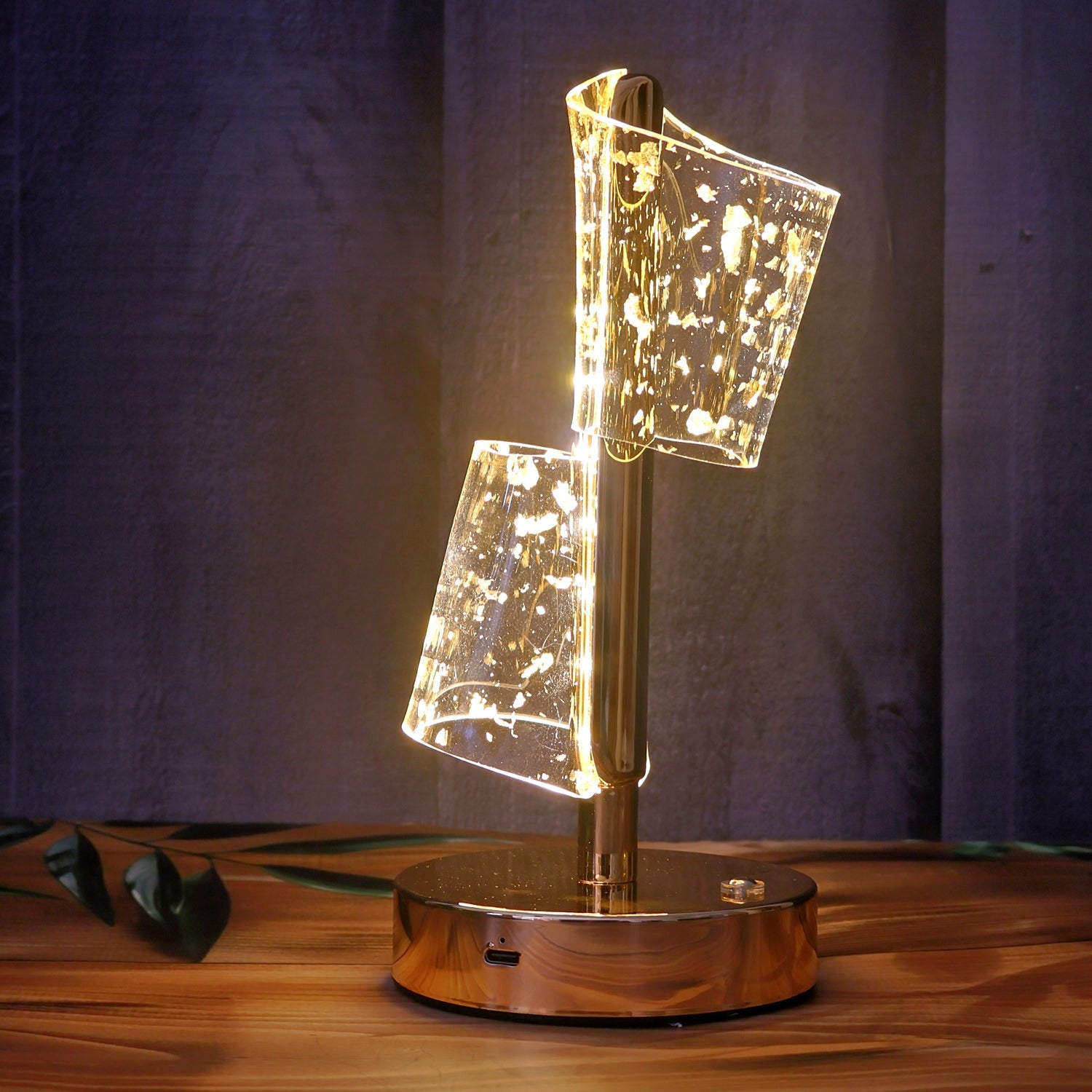 Close-up of golden metallic base of crystal LED double shade table lamp