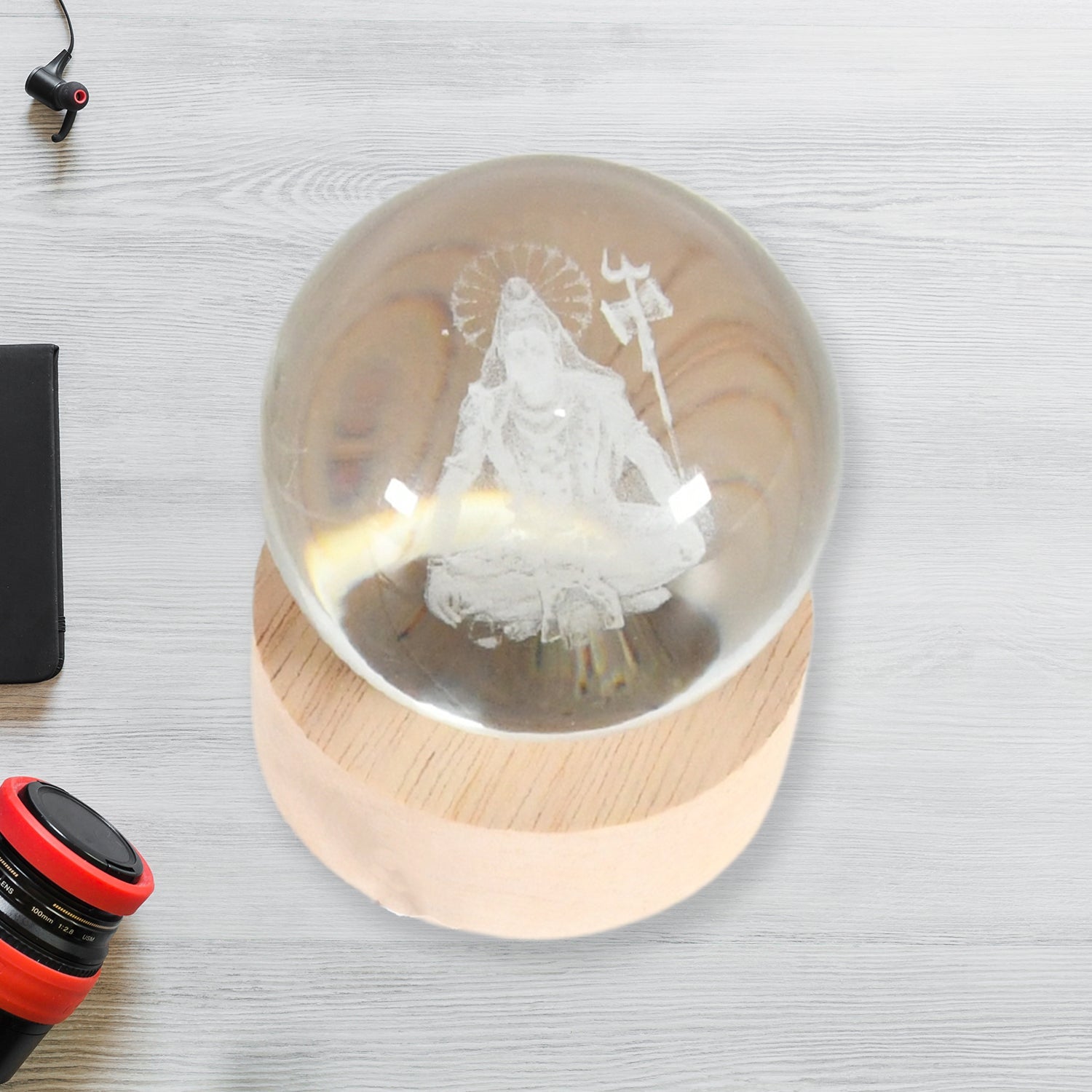 The  3D Crystal Ball Lamp creating a serene ambiance on a bedside table in a modern bedroom.