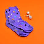 Two pairs of trendy designer socks for women, showcasing different fun prints.
