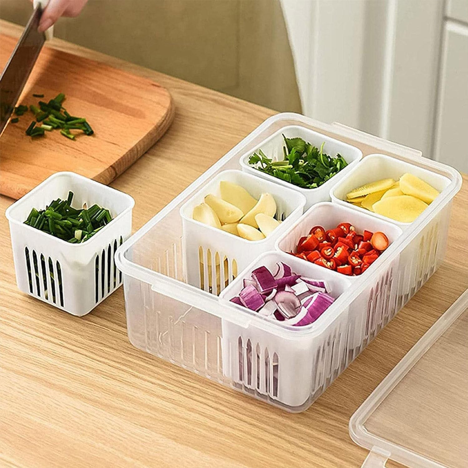 Clear plastic fridge storage box filled with fresh vegetables and meat for organized food prep.