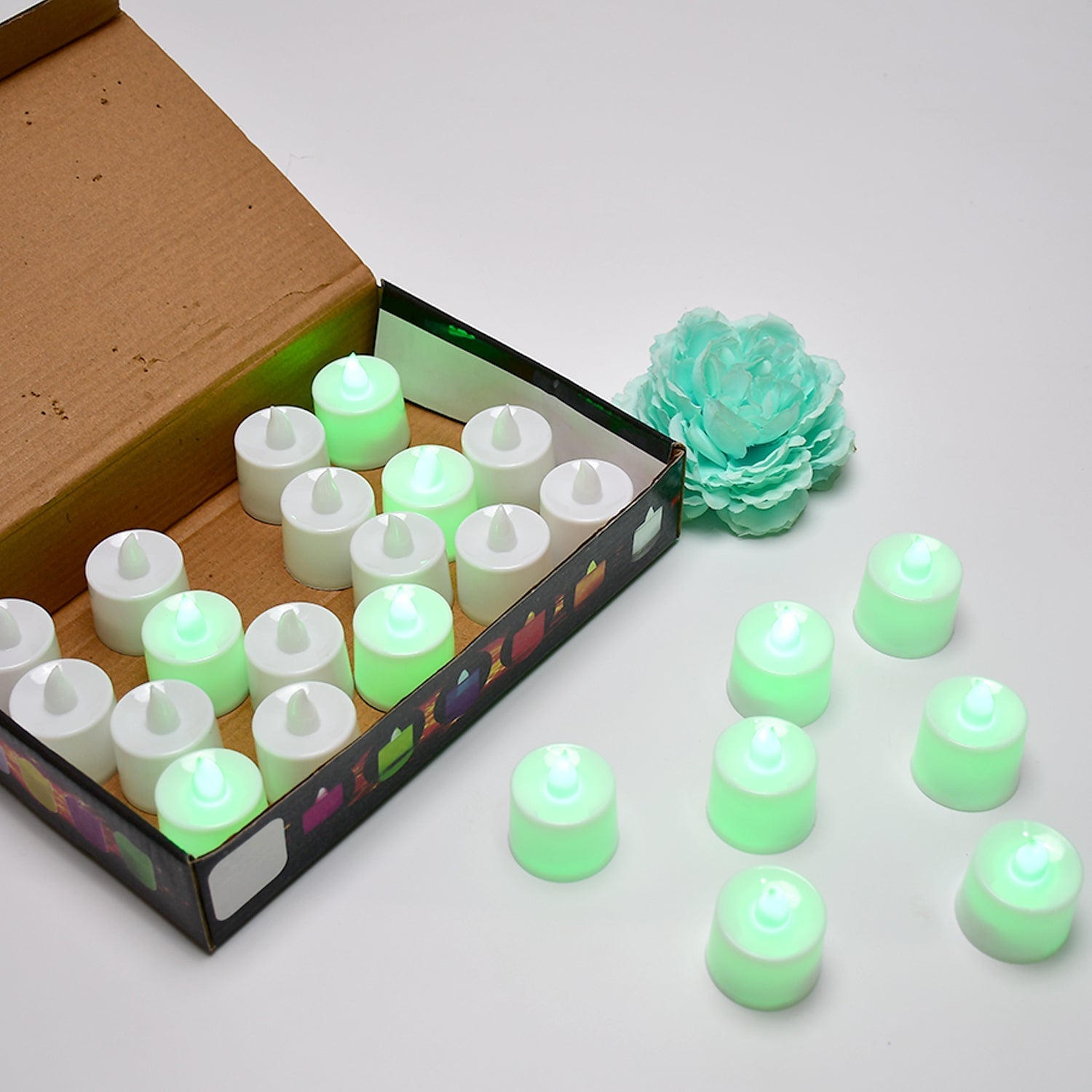 A pack of 24 green flameless LED tealights ready for use.