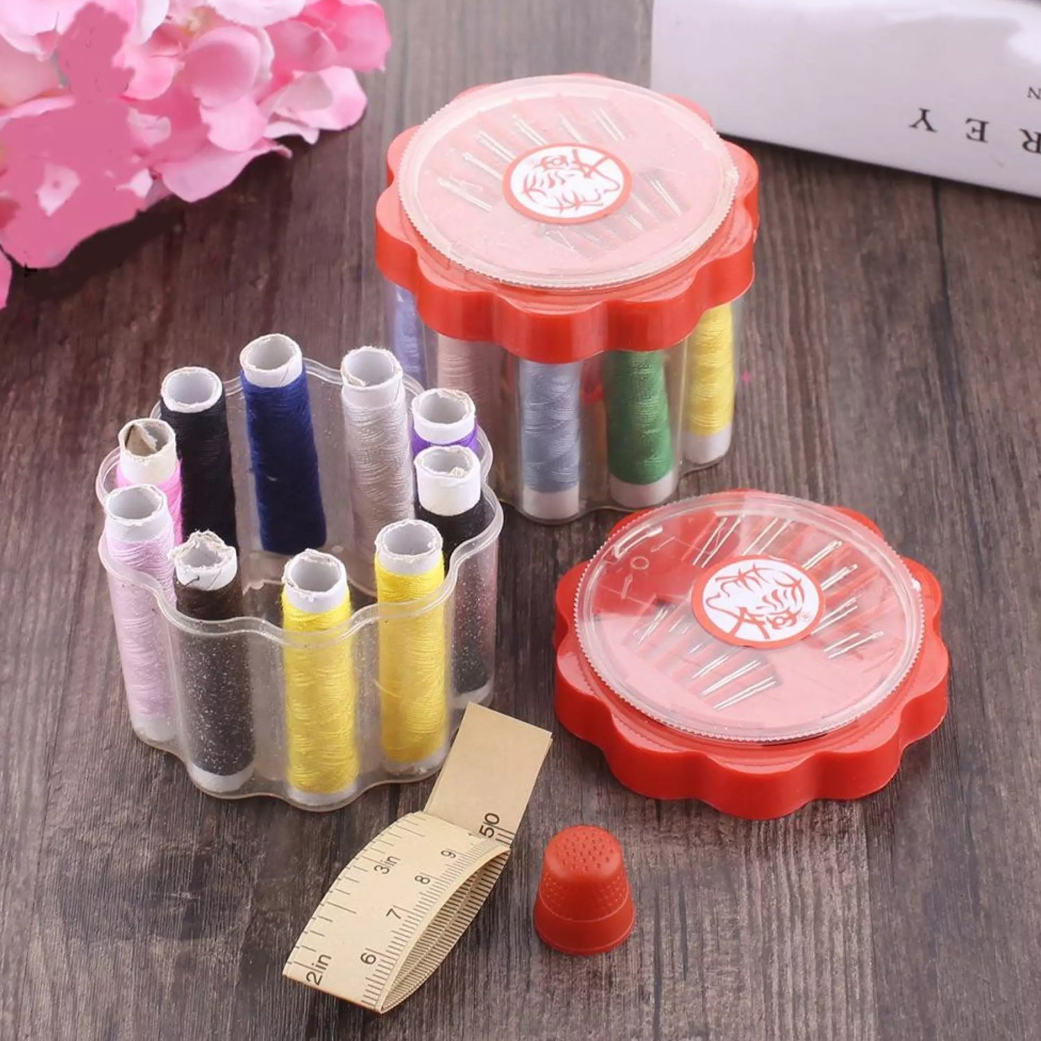 Compact sewing box open, revealing organized threads and sewing tools.