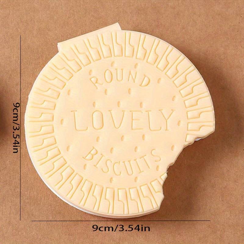A child's hand holding the fun biscuit notebook, perfect for early learning and creative writing.