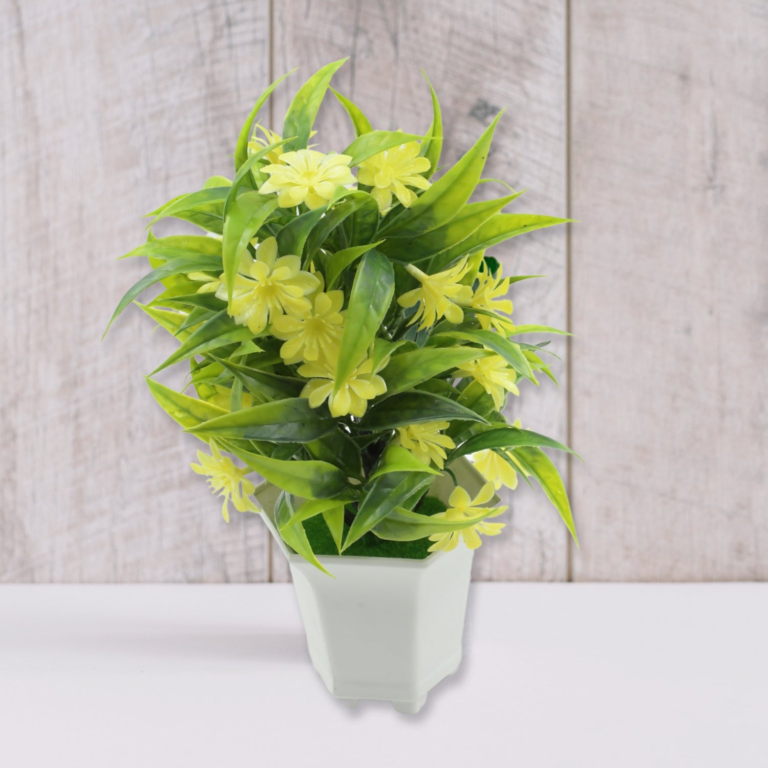 Detailed close-up of vibrant artificial yellow flowers and lush green leaves.