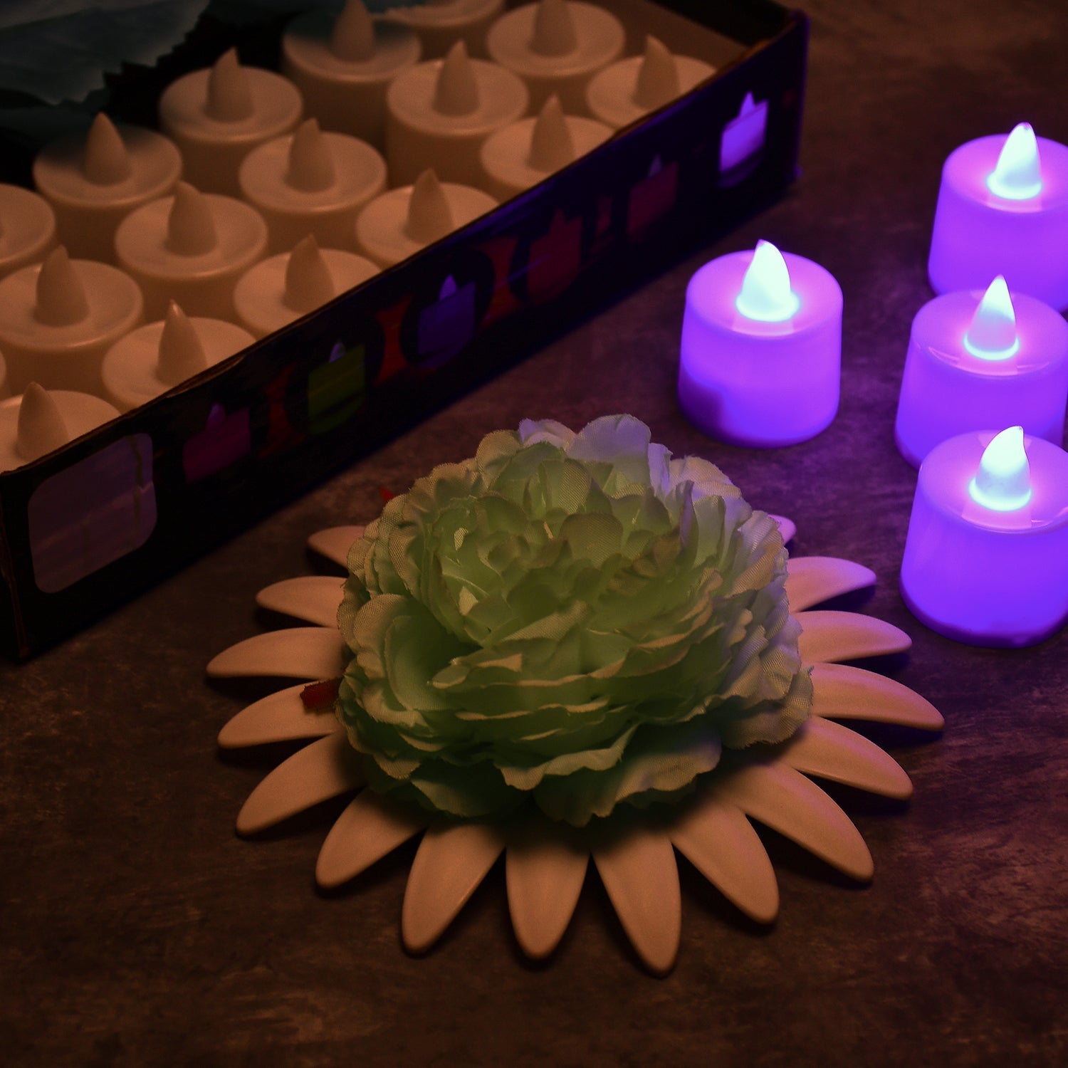 Decorative pink smokeless tealight candles illuminating a festive setting.