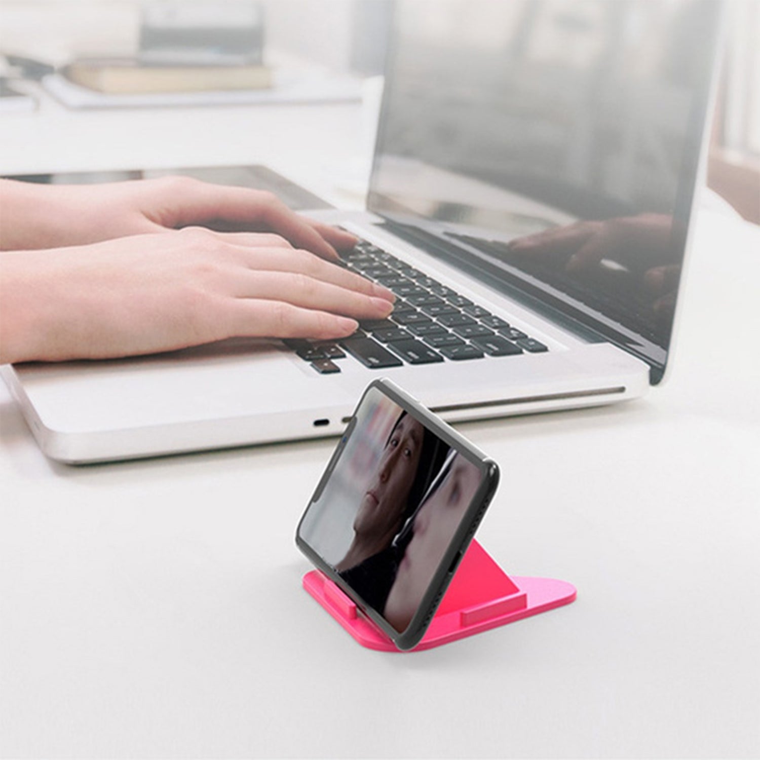 Pyramid mobile stand in black, showcasing its compact design and multiple viewing angles.