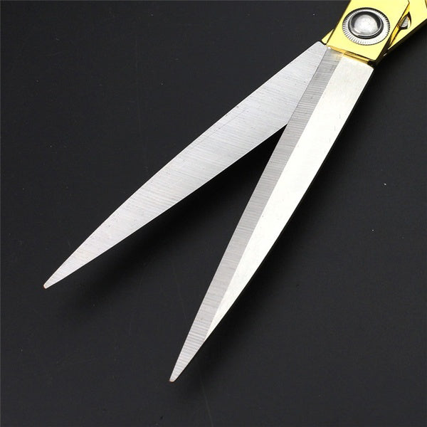 Side view of gold-plated dressmaker shears, ideal for various craft materials.