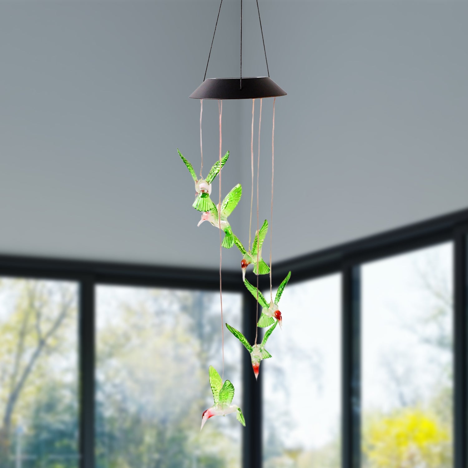 Multicolor LED glowing hummingbird wind chime shining at night