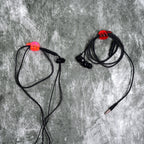 A set of multi-functional hand shape wall clips holding various items like cables and keys.