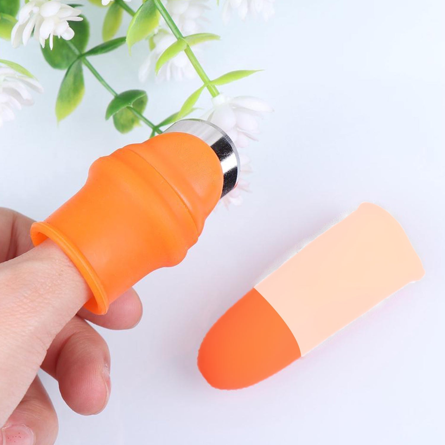 Close-up of the ergonomic vegetable thumb cutter on a hand.