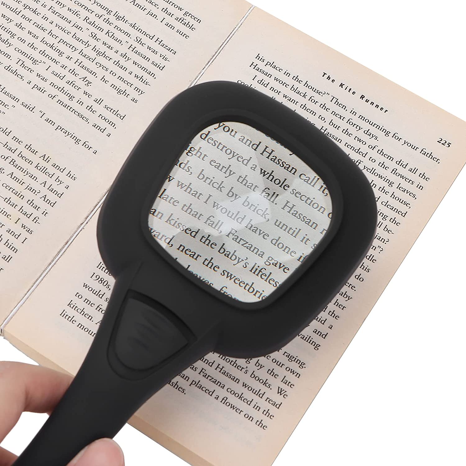 Handheld LED magnifying glass illuminating a coin for detailed inspection.