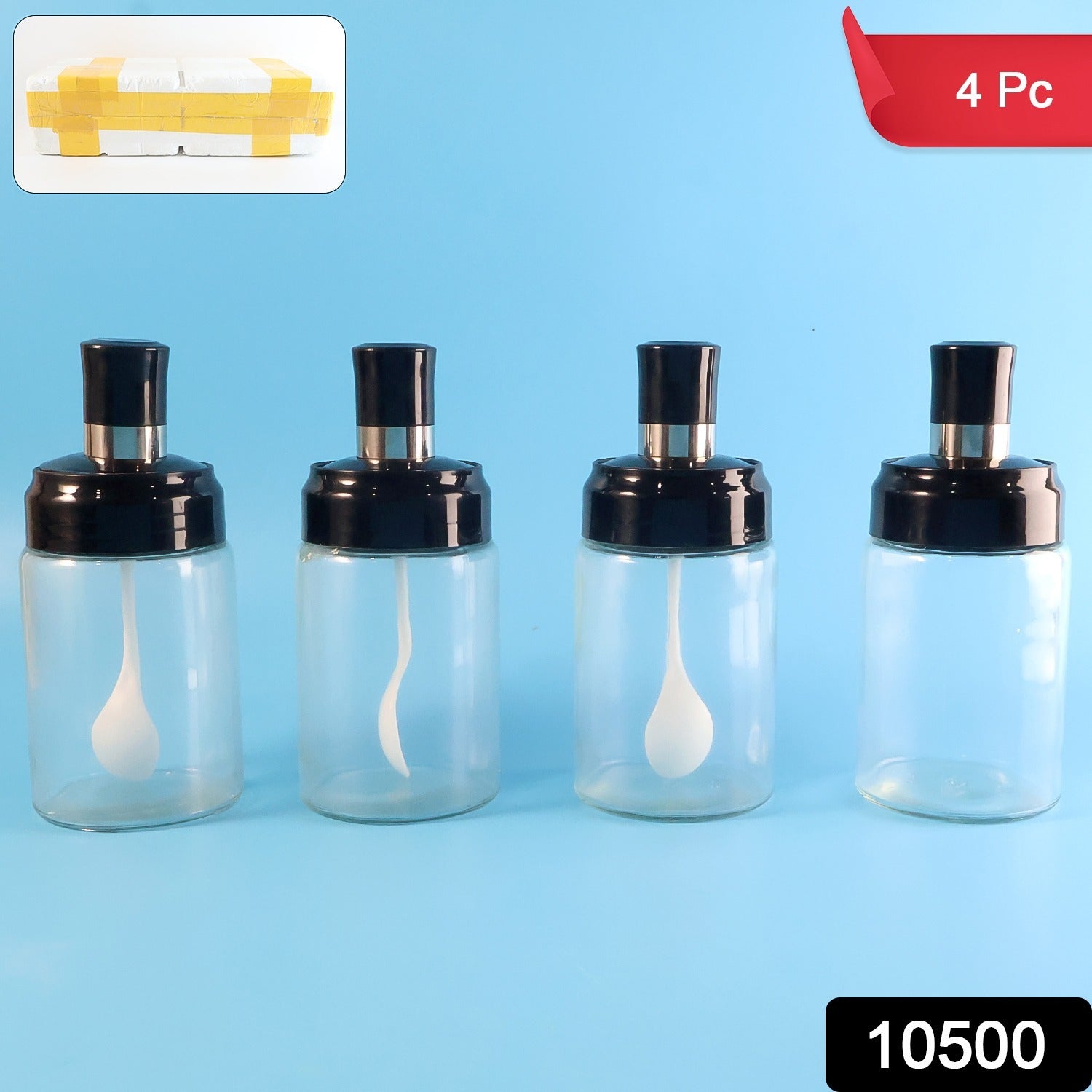 Set of four clear spice storage bottles with built-in spoons and airtight lids