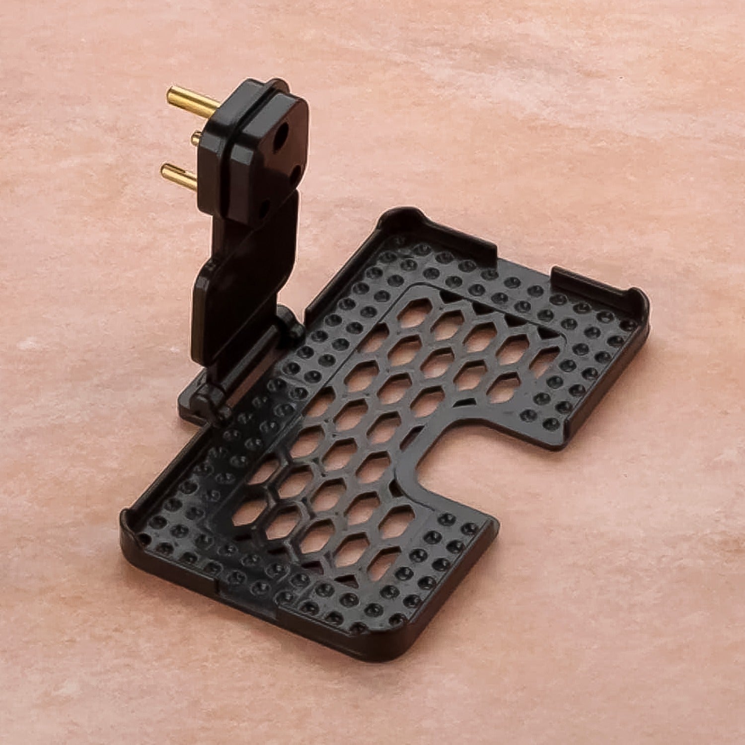 Close-up of the Mobile Charging Holder's open slots for ventilation and stable three-pin support.