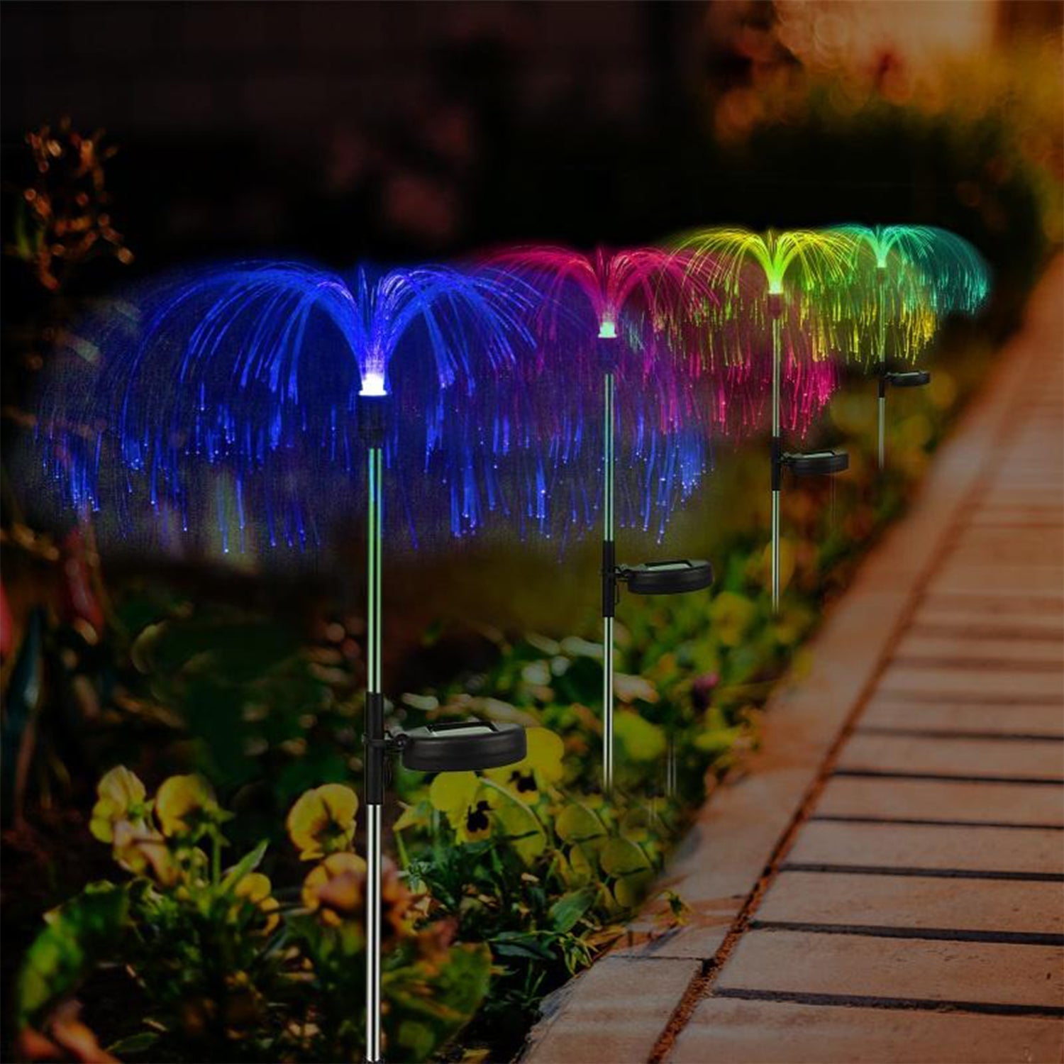 Pair of solar powered garden lights with RGB fiber optic colors glowing