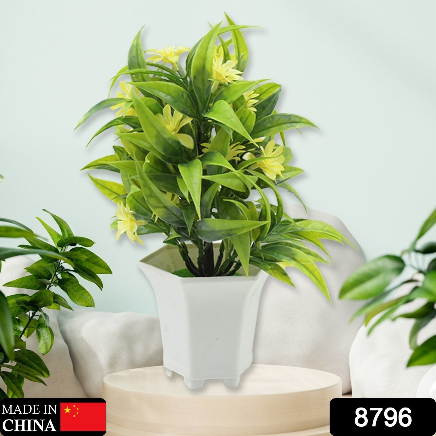 Close-up of realistic artificial yellow flowers in a stylish white pot.