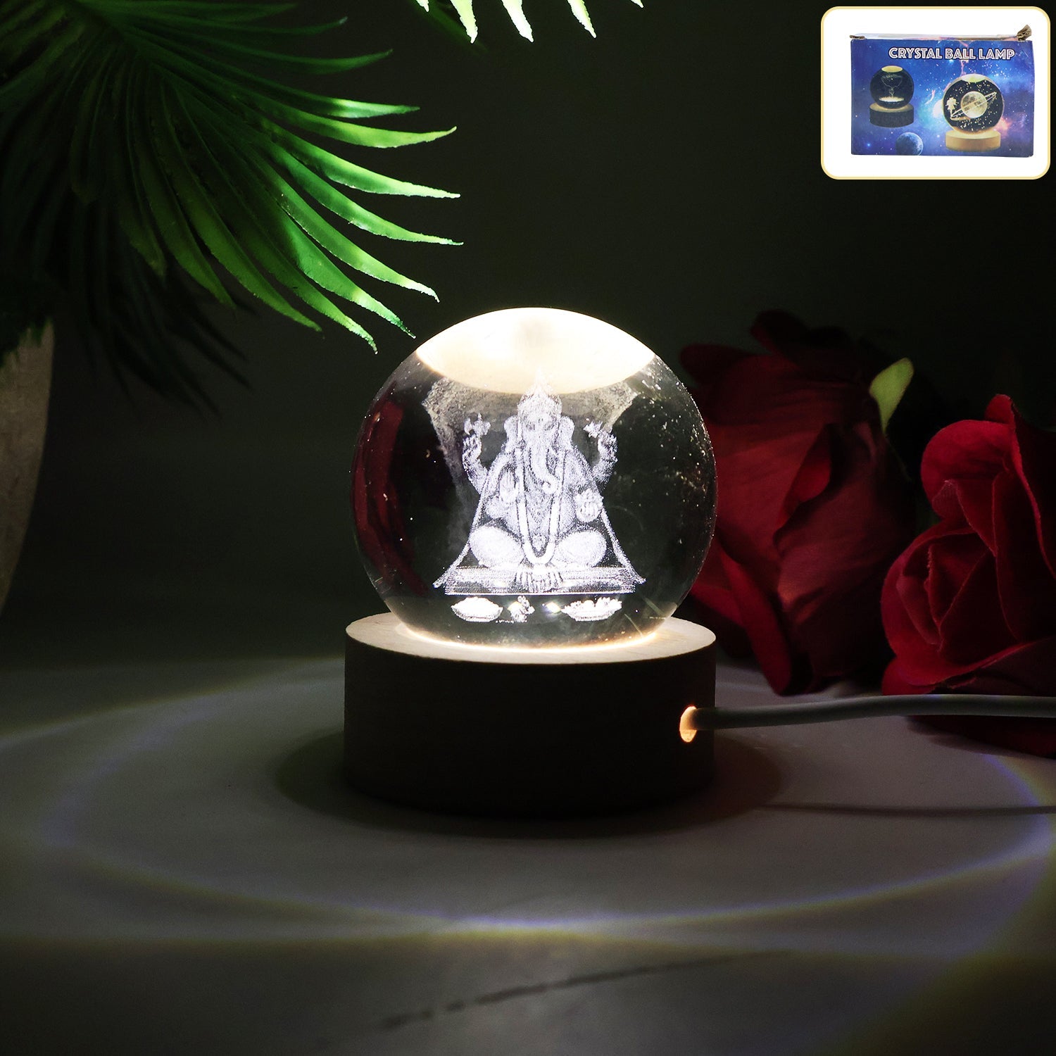 Close-up of a Ganesha 3D Crystal Ball Lamp radiating a warm glow.