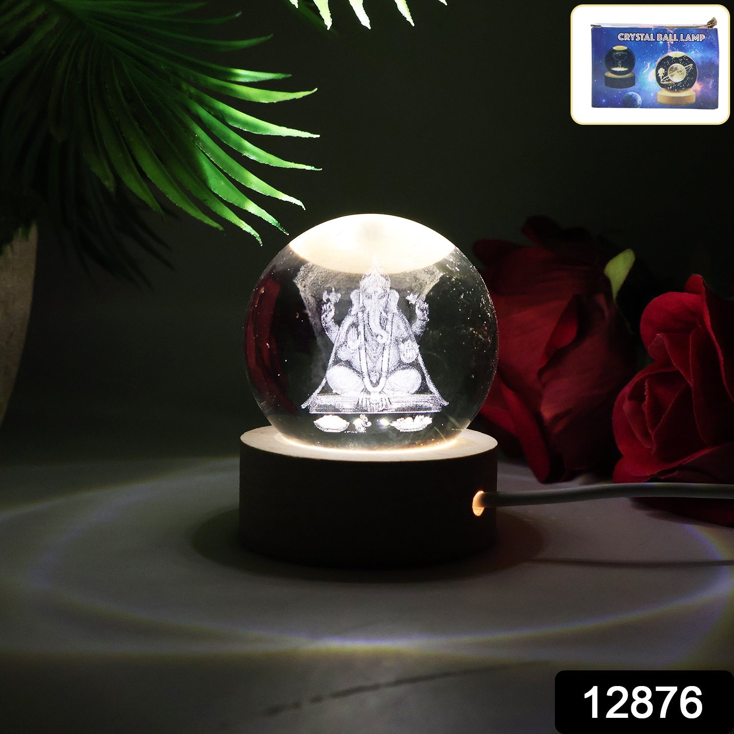 Ganesha 3D Crystal Ball Lamp illuminating a desk, showcasing its intricate design.