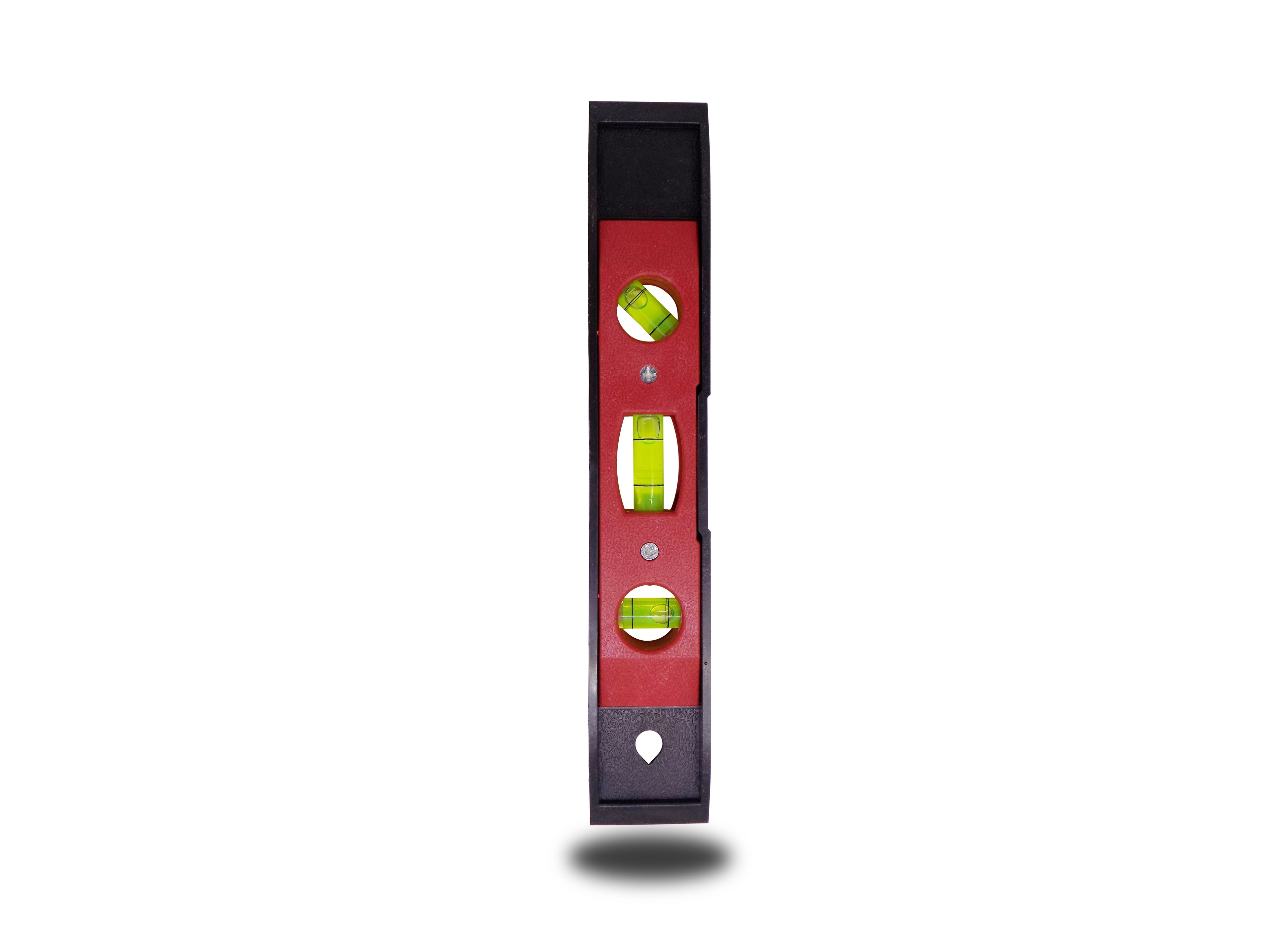 Magnetic torpedo level in hand, demonstrating its ergonomic grip.