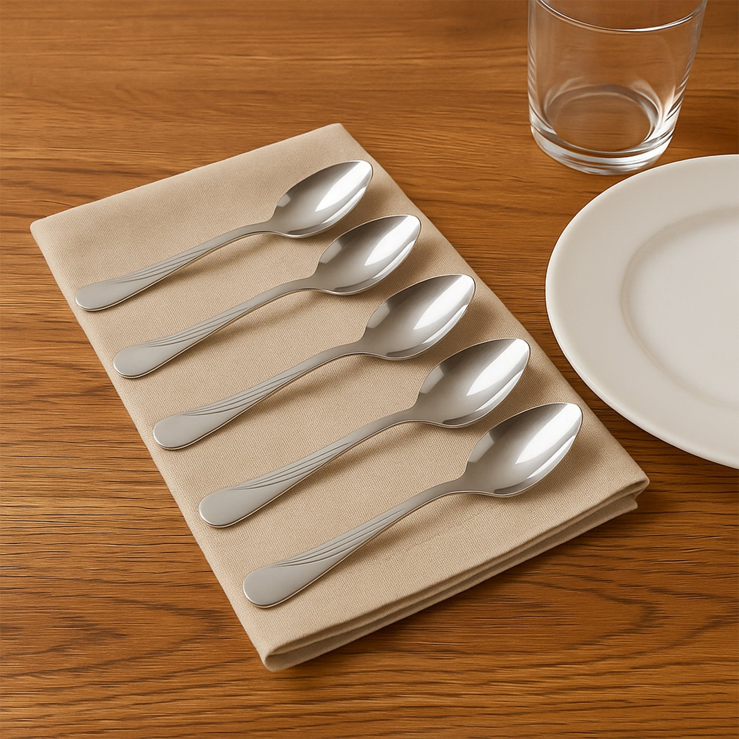 Close-up of elegant stainless steel dining spoons with engraved handles