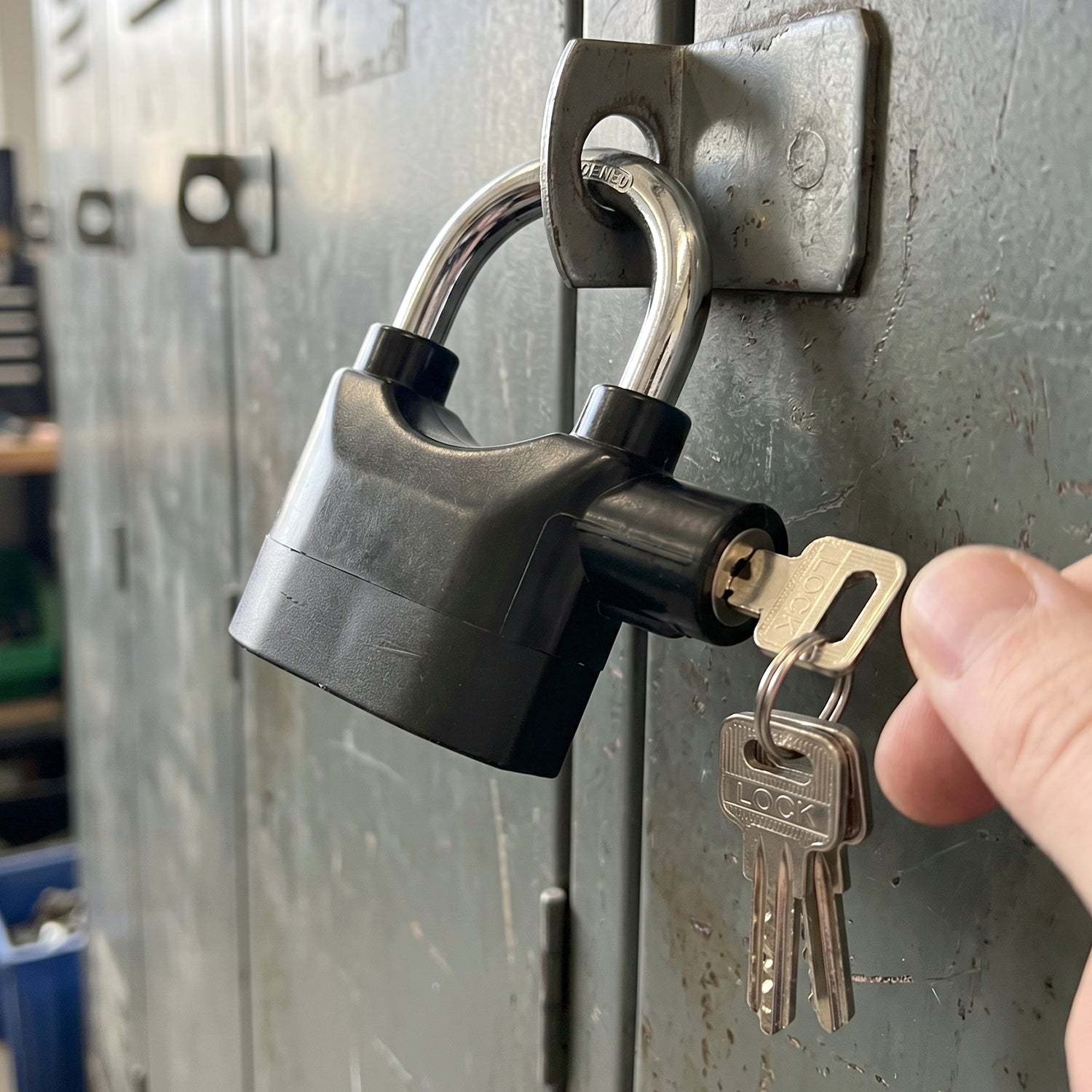 Three unique keys for the anti-theft alarm padlock, ready for secure operation.