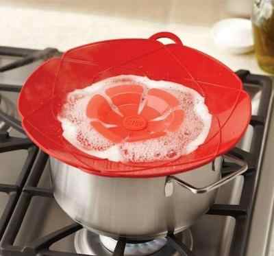 Silicone Spill Stopper Lid preventing boil-over on a cooking pot.