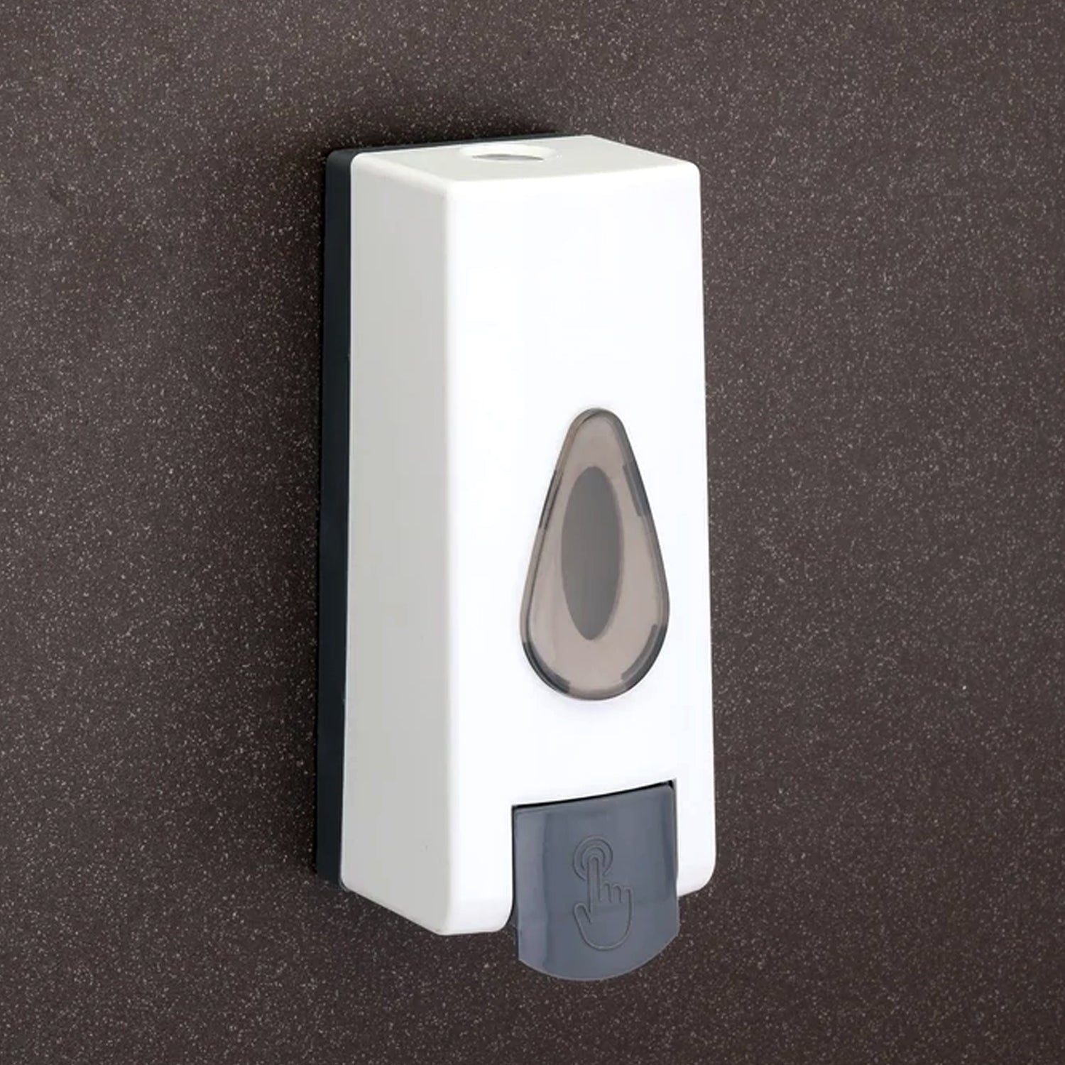 Close-up of the push-button mechanism on the wall mounted soap dispenser.