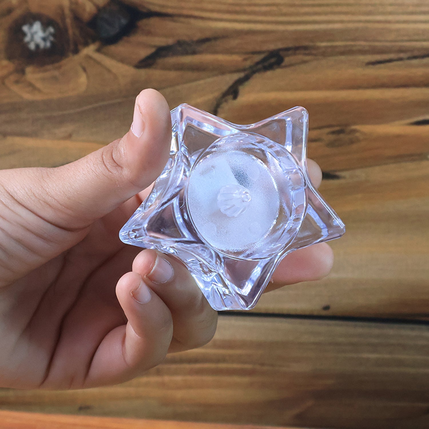 Close-up of star-shaped LED candle with realistic flickering flame
