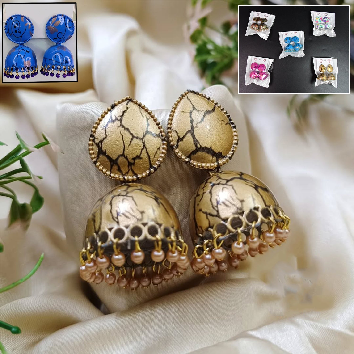 Close-up of a pair of intricate gold-toned Jhumka Earrings with pearl drops, perfect for traditional Indian wear.