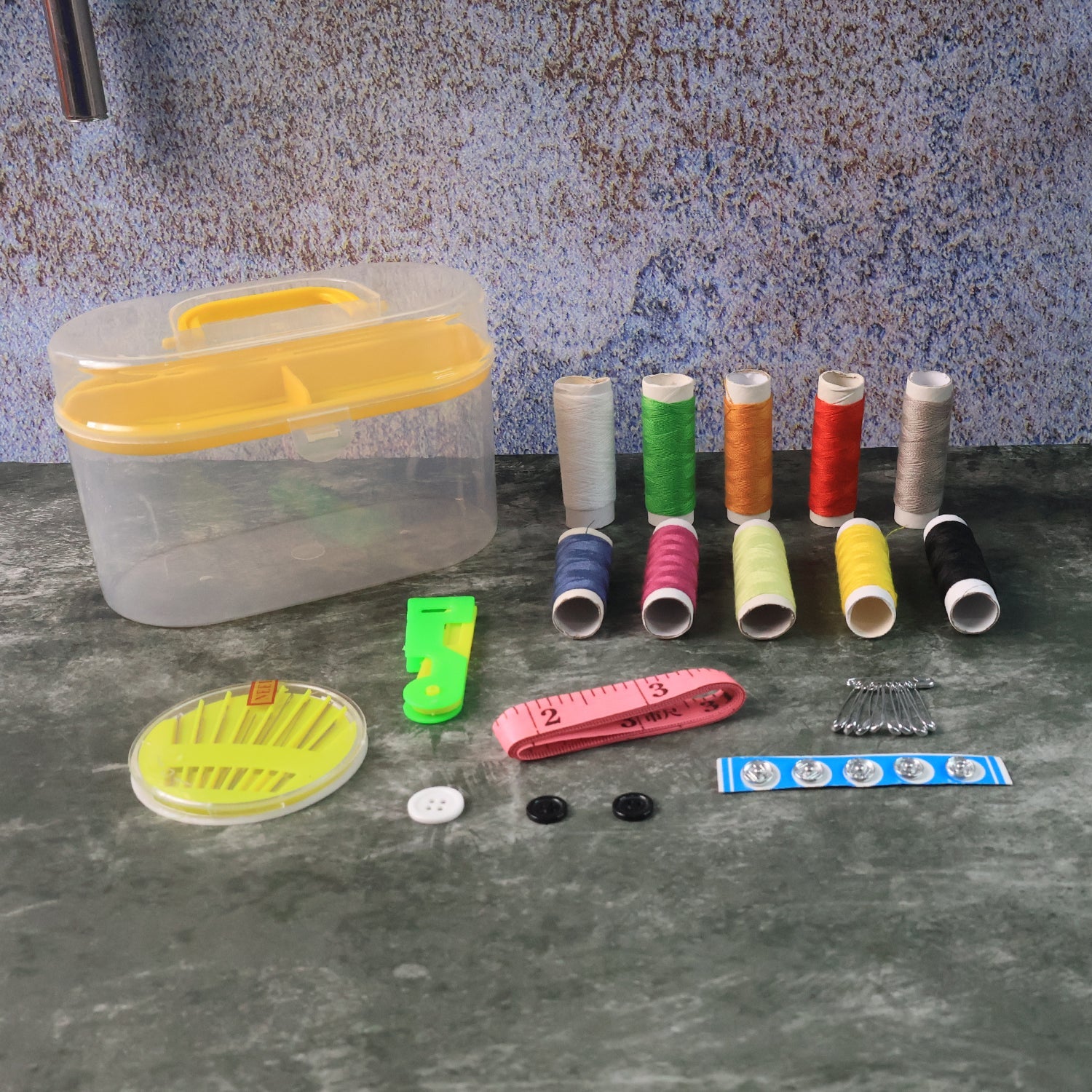 Double layer sewing kit with elastic straps securing tools in neat compartments.